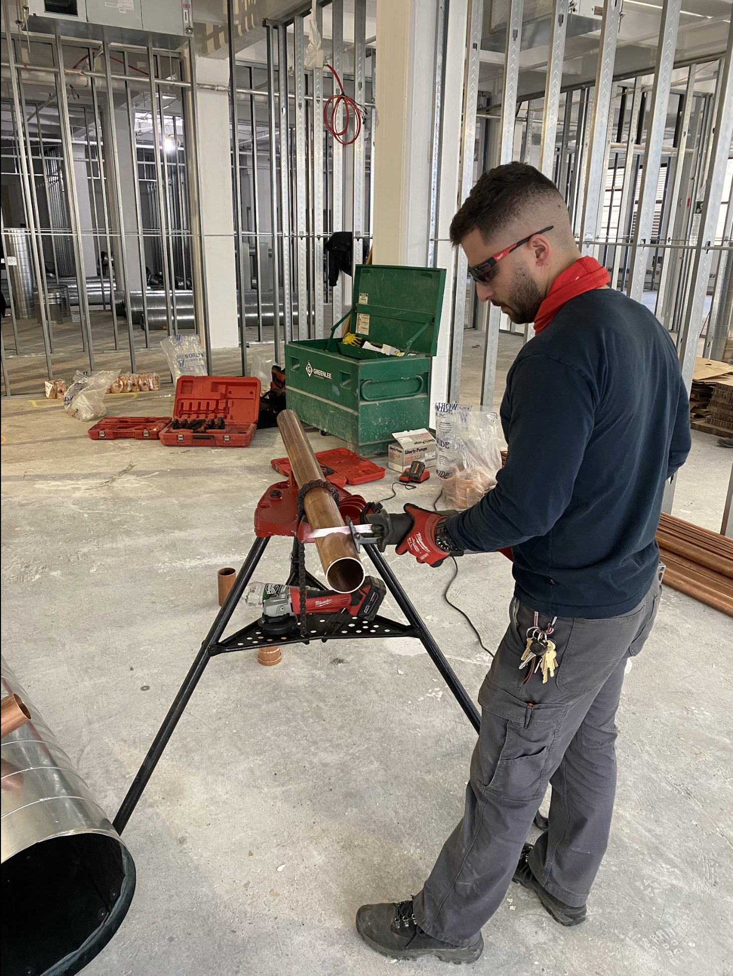 Aleksander threading copper pipe on a commercial buildout in Bushwick, Brooklyn