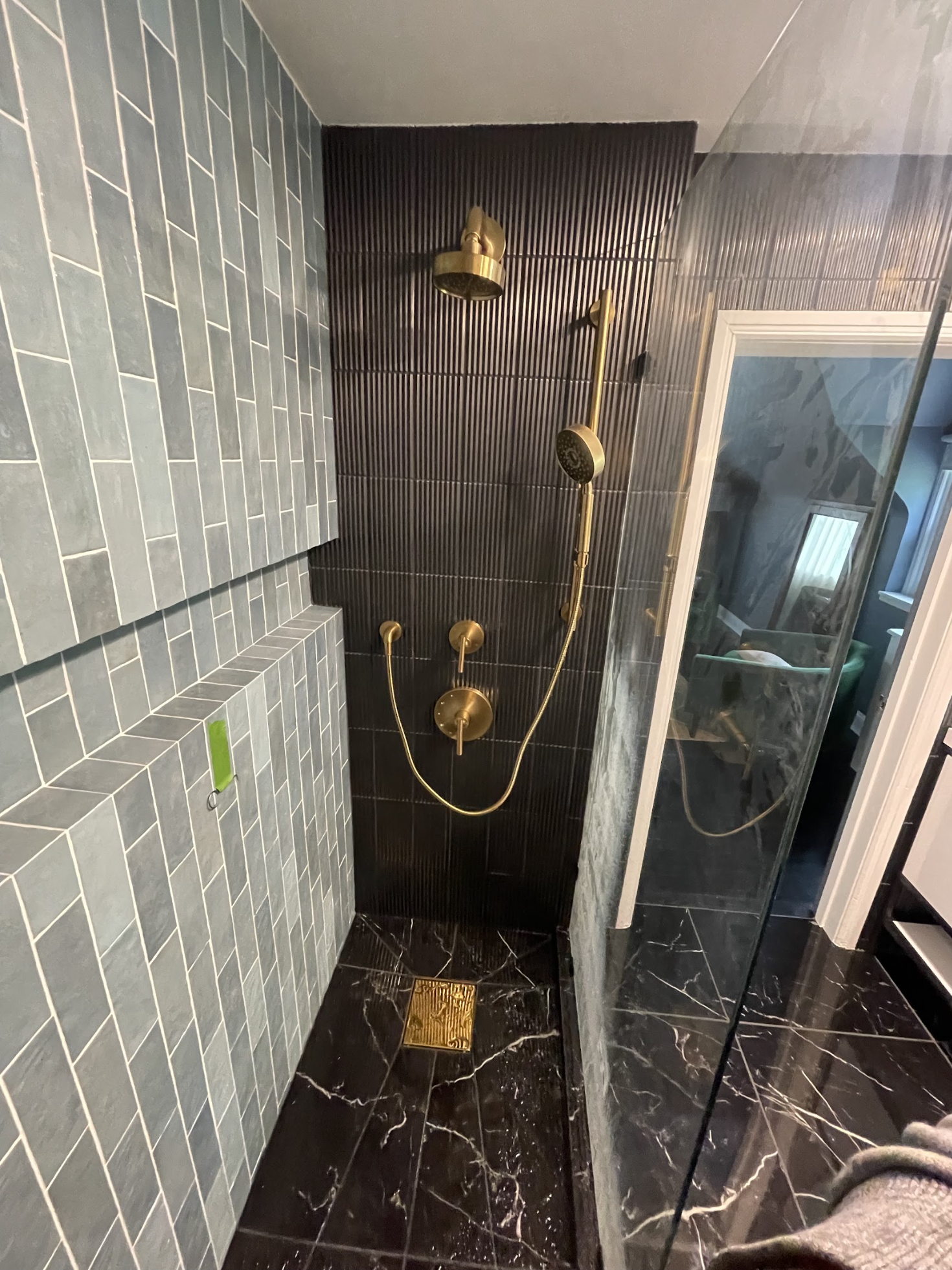 Completed luxury marble shower with brass fixtures and rain showerhead in a Glendale pre-war home, installed by We Pipe LLC