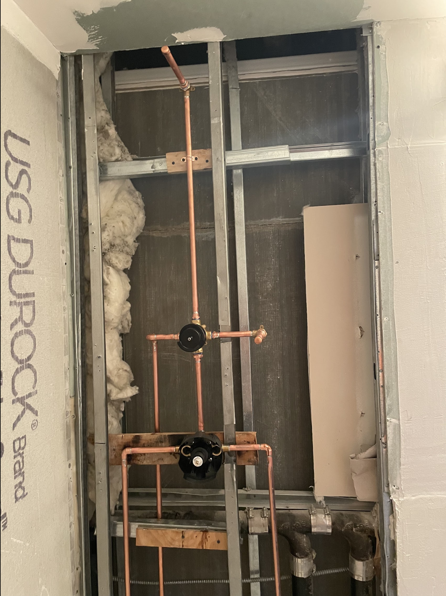 Permitted shower valve replacement rough-in with copper supply stubs in wall cavity of a Jackson Heights apartment — We Pipe LLC licensed plumber